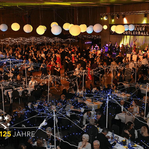 Beleuchteter Festsaal mit tanzenden Gästen unter Regenschirmen aus Lichtern, zur Feier des 125-jährigen Jubiläums.