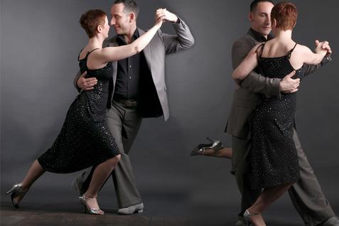 Tanzpaar in eleganter Kleidung tanzt eng umschlungen, auf grauem Hintergrund, ausdrucksvoll und harmonisch.