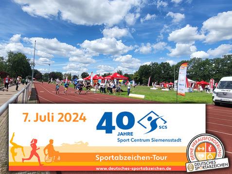 Sportveranstaltung auf einer Laufbahn mit Teilnehmern, bunten Zelten und Fahnen im Hintergrund unter bewölktem Himmel.